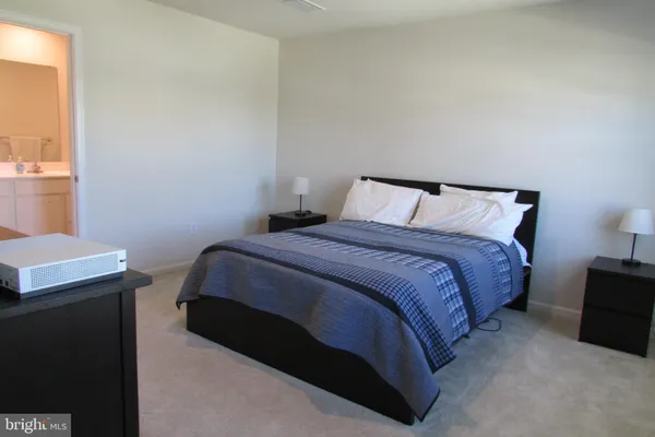 a bedroom with a bed and a table in it