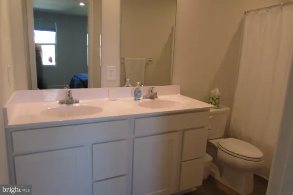 a bathroom with a sink toilet and mirror