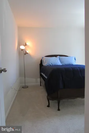 a bedroom with a bed and a table