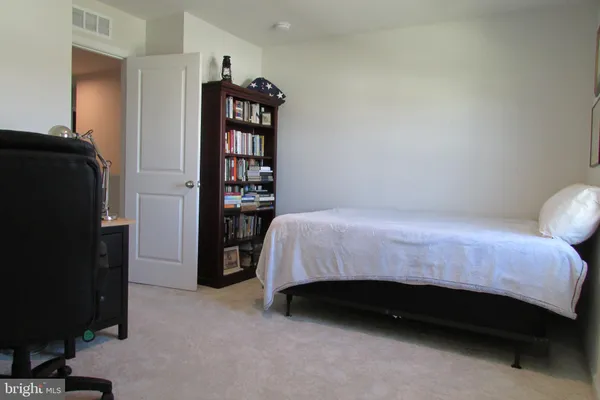 a bedroom with a bed and a walk in closet