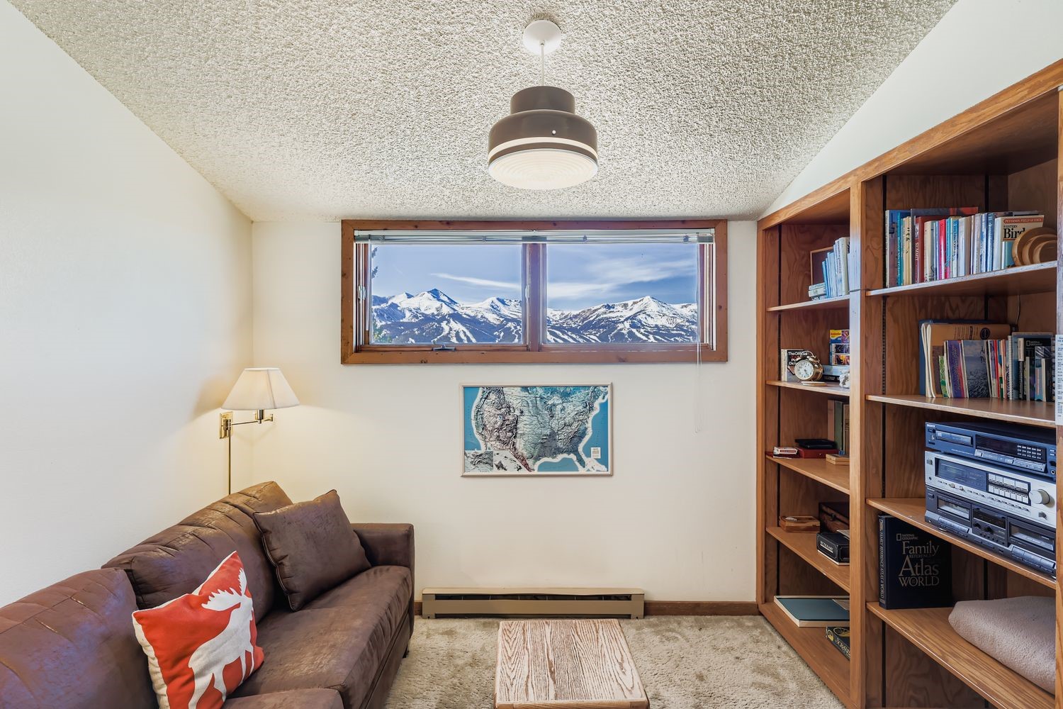 93 Fuller Placer Road, Unit F Breckenridge, CO 80424 - Photo 12 of 26 a living room with furniture and a book shelf