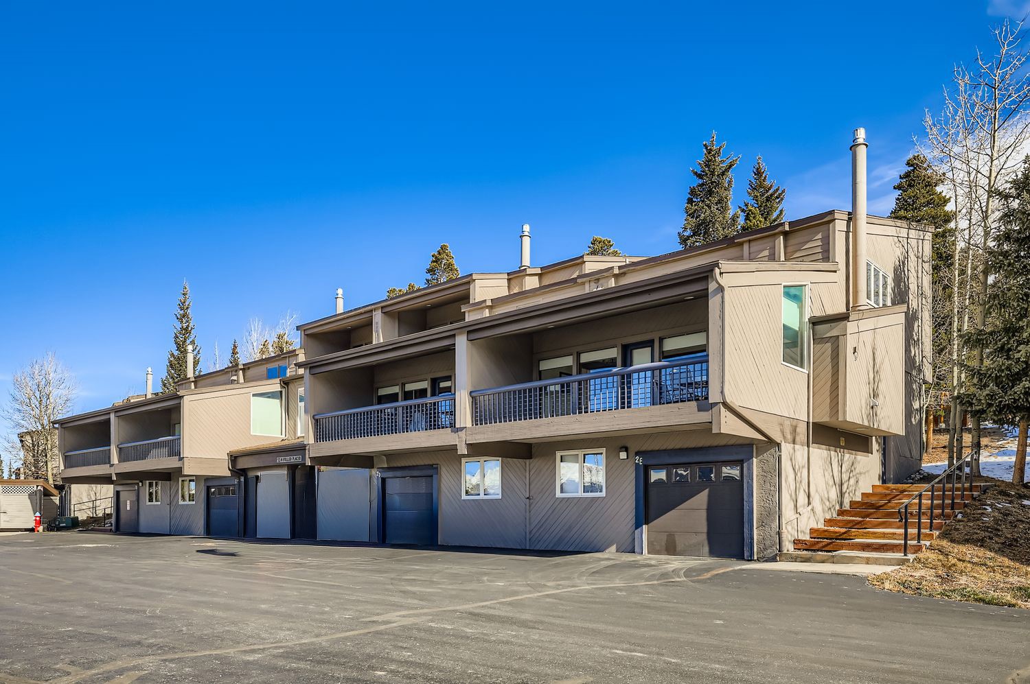 93 Fuller Placer Road, Unit F Breckenridge, CO 80424 - Photo 25 of 26 a view of a large building next to a road