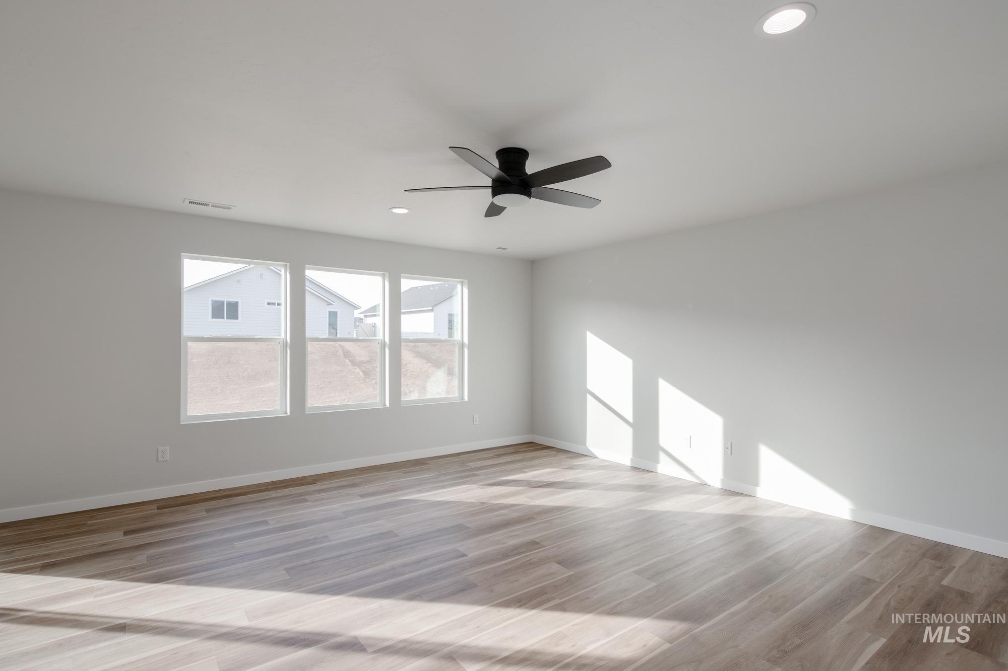 1613 Covington Street Middleton, ID 83644 - Photo 11 of 25 Unfurnished room with ceiling fan, light wood finished floors, and recessed lighting
