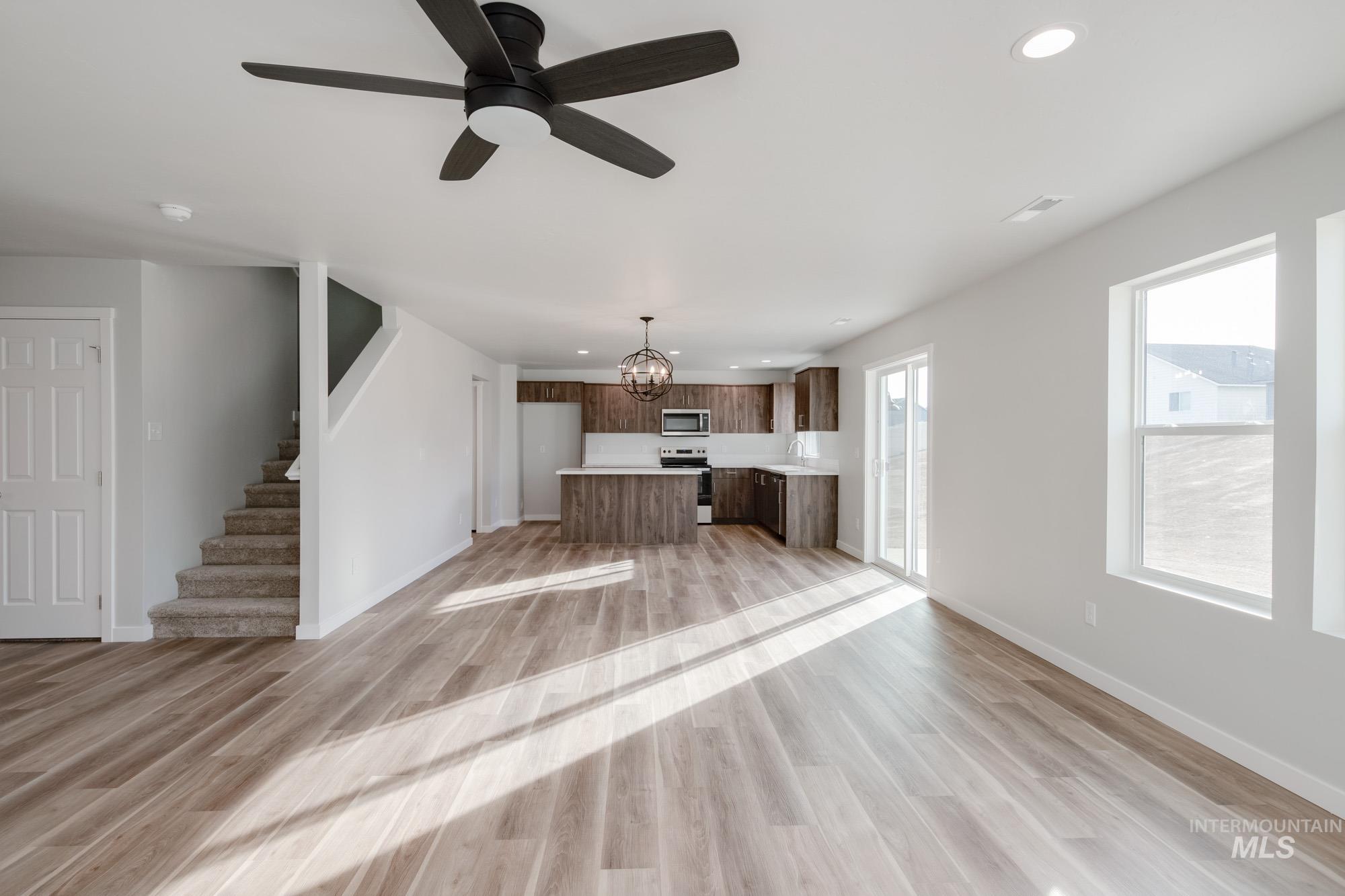 1613 Covington Street Middleton, ID 83644 - Photo 13 of 25 Unfurnished living room with ceiling fan, suspended lighting, and light wood-style flooring