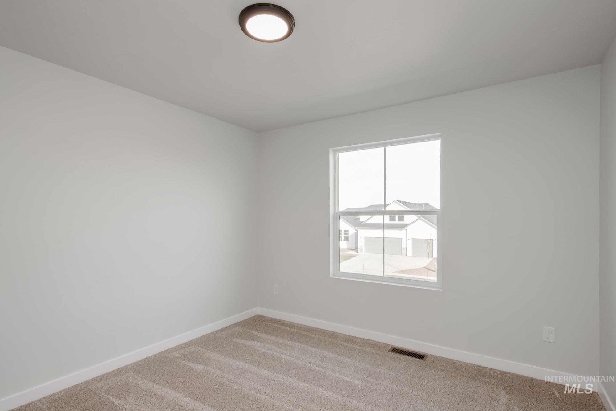 1613 Covington Street Middleton, ID 83644 - Photo 17 of 25 Carpeted spare room featuring baseboards