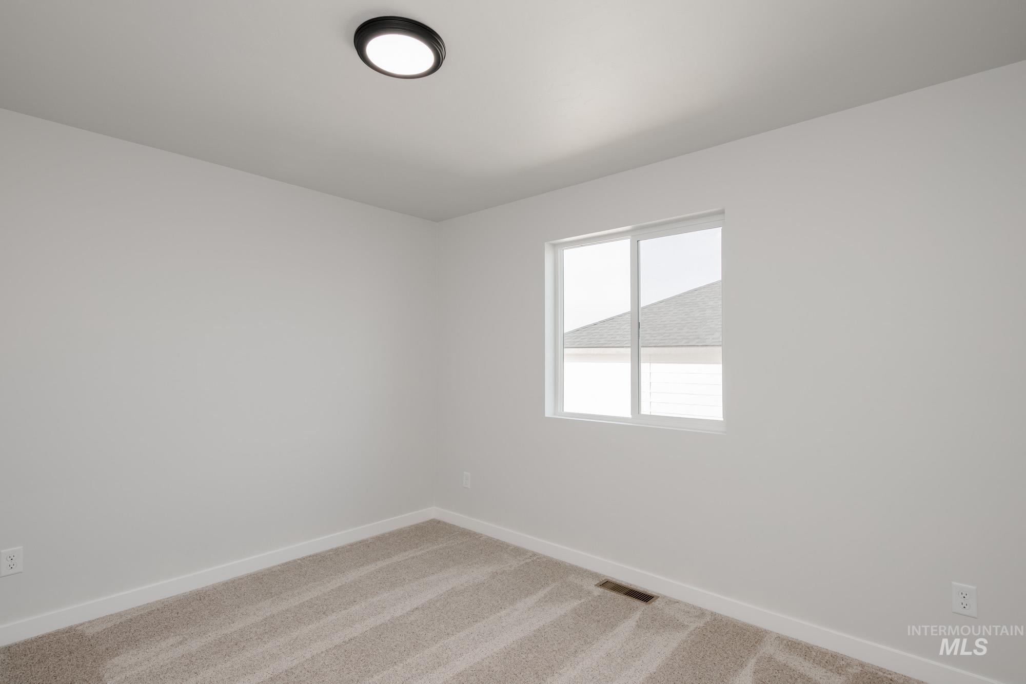 1613 Covington Street Middleton, ID 83644 - Photo 18 of 25 Unfurnished room with baseboards and carpet floors