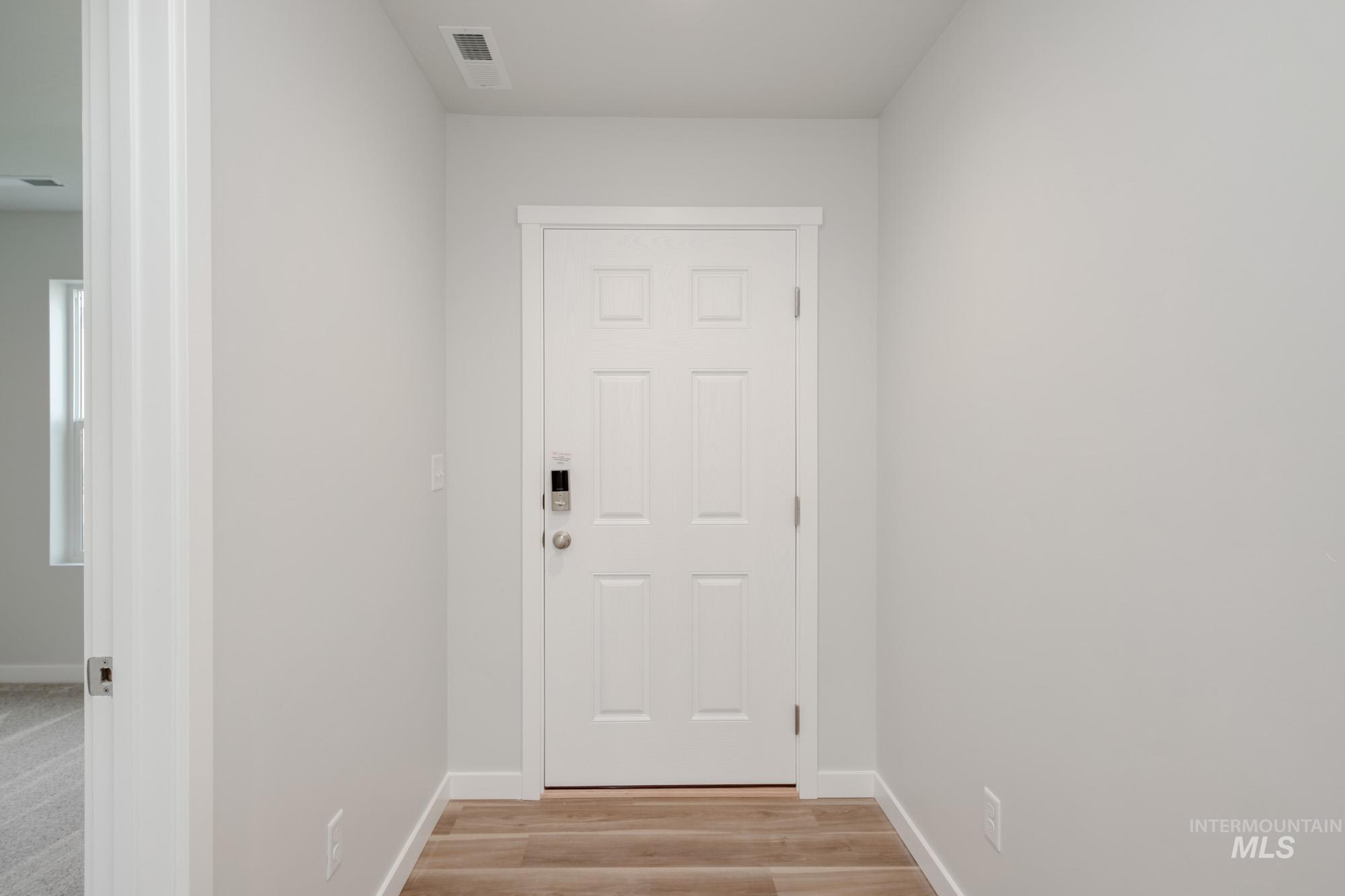 1613 Covington Street Middleton, ID 83644 - Photo 2 of 25 Doorway to outside with baseboards and wood finished floors