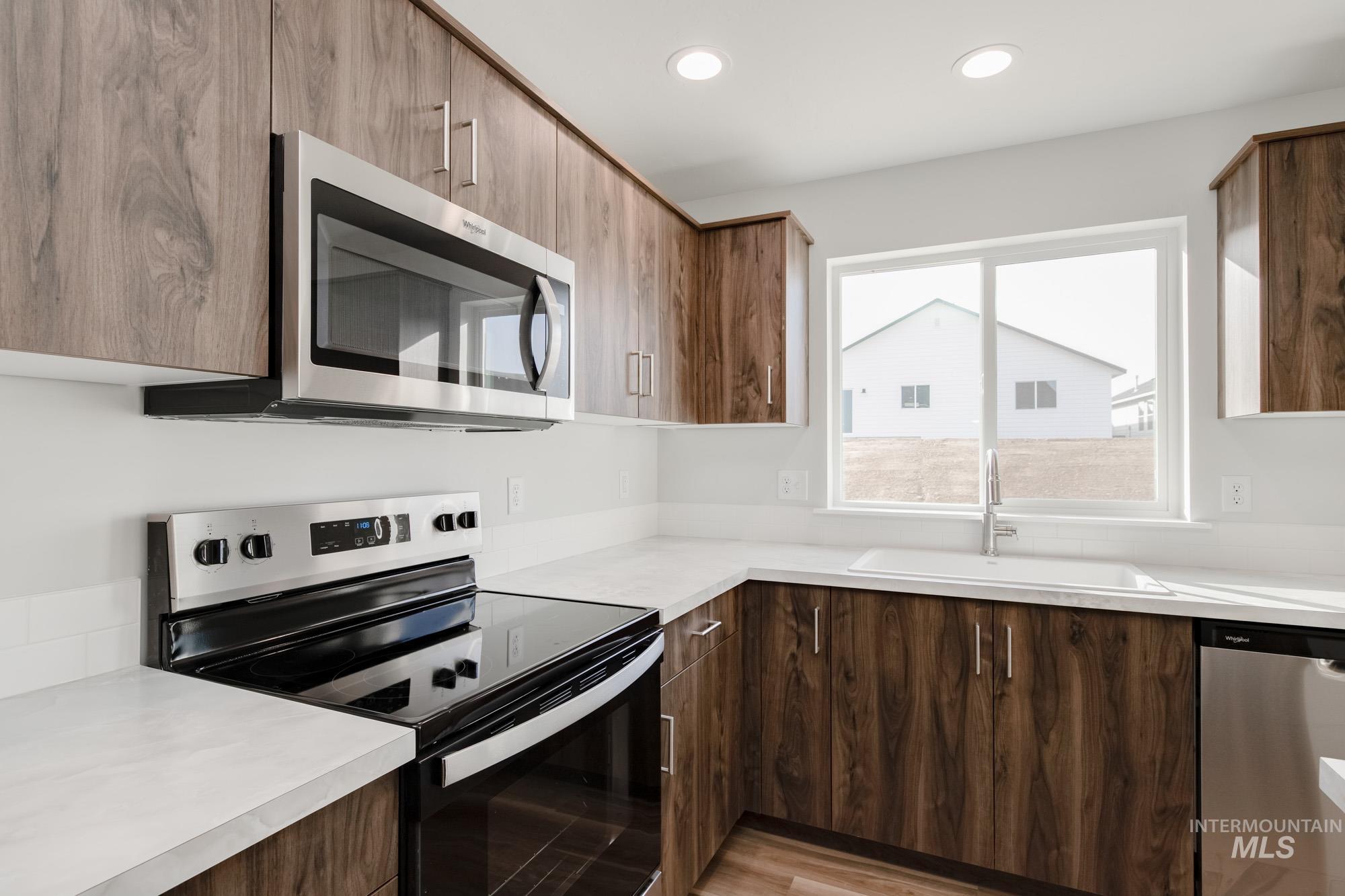 1613 Covington Street Middleton, ID 83644 - Photo 7 of 25 Kitchen featuring stainless steel appliances, modern cabinets, light countertops, and recessed lighting