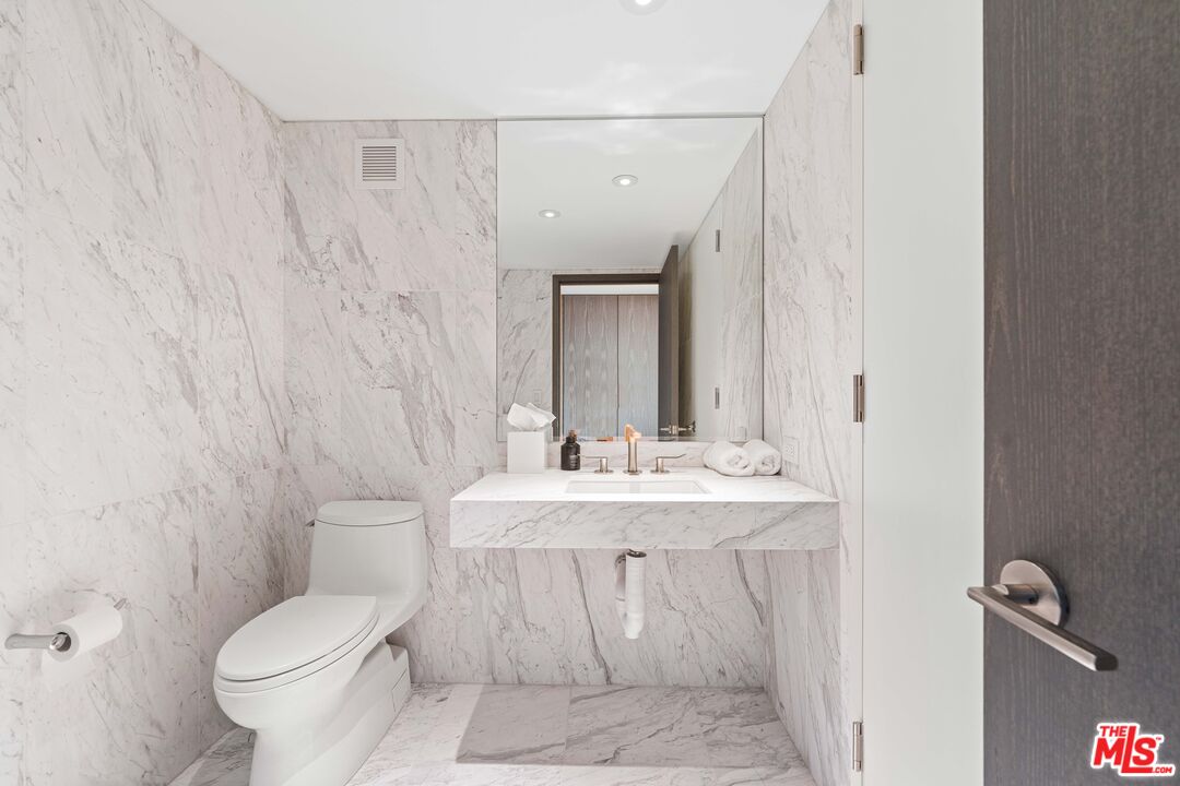 2025 Avenue Of The Stars, Unit 1202 Los Angeles, CA 90067 - Photo 13 of 20 a bathroom with a toilet sink and mirror