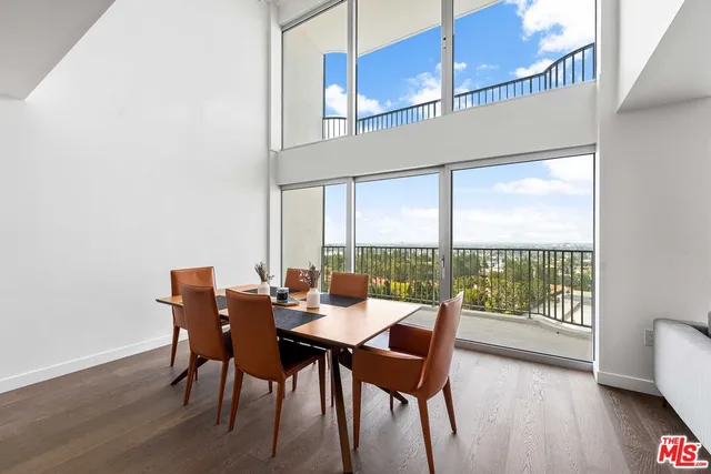 a dining room with furniture window and wooden floor