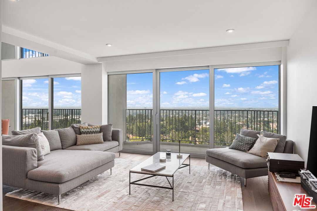 2025 Avenue Of The Stars, Unit 1202 Los Angeles, CA 90067 - Photo 4 of 20 a living room with furniture and a floor to ceiling window