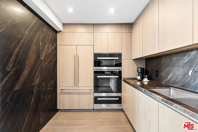 a kitchen with granite countertop a refrigerator and a sink