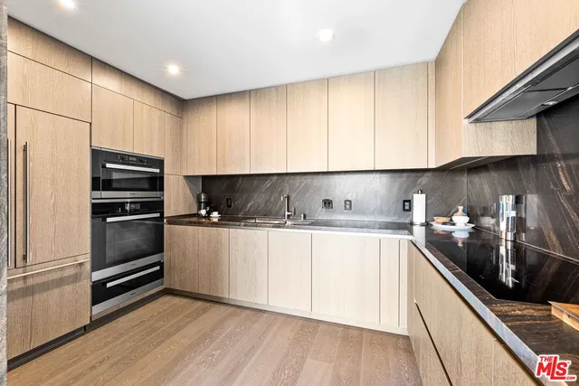 a kitchen with a sink a stove and refrigerator