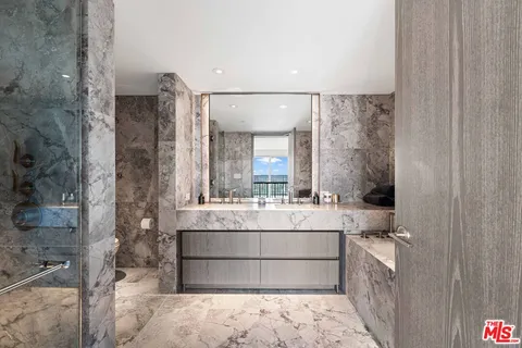 a large white bathroom with a large mirror