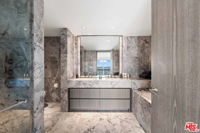 a large white bathroom with a large mirror