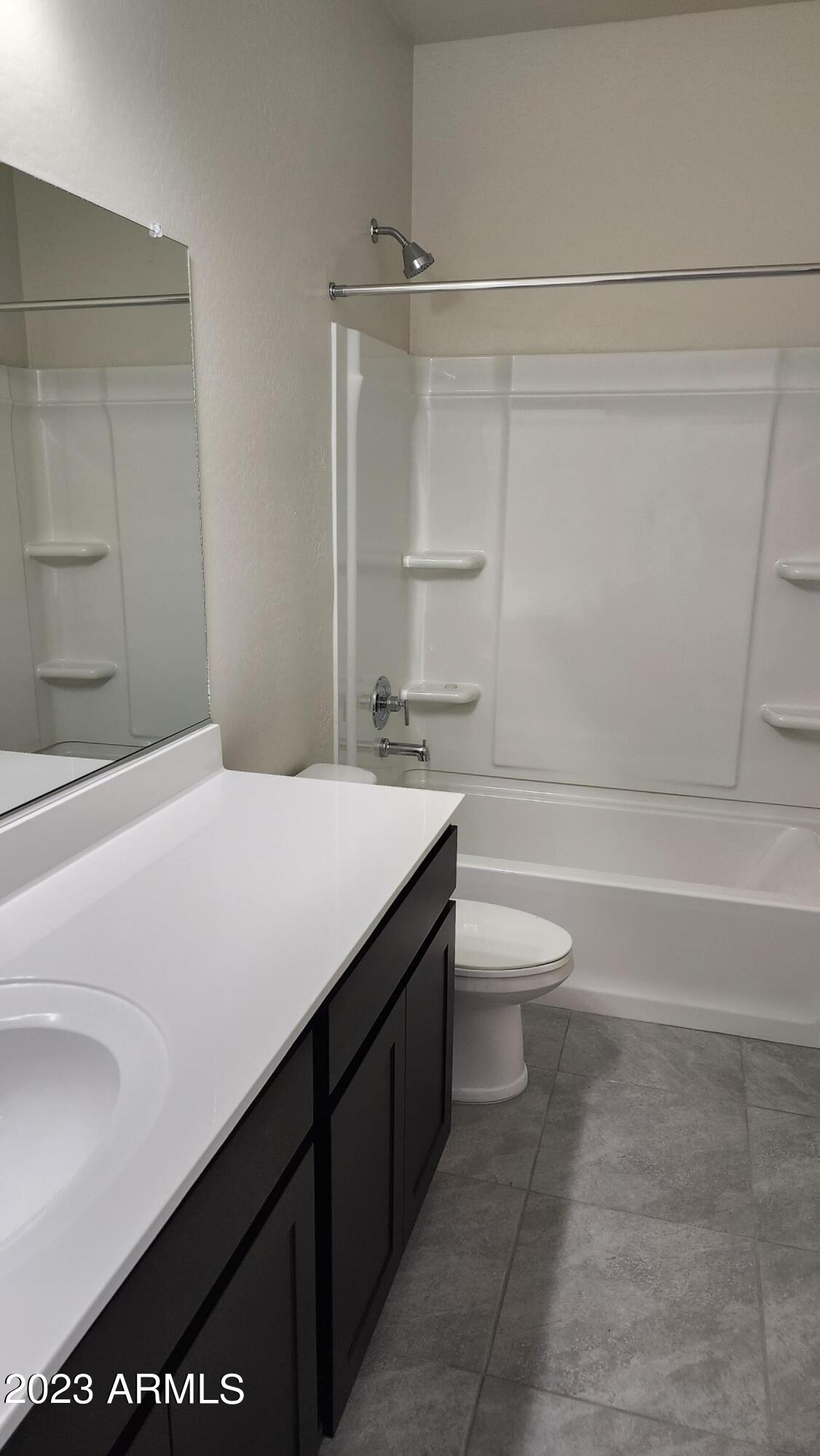 18045 North Conquistador Drive Maricopa, AZ 85138 - Photo 6 of 12 a bathroom with a granite countertop sink toilet and shower