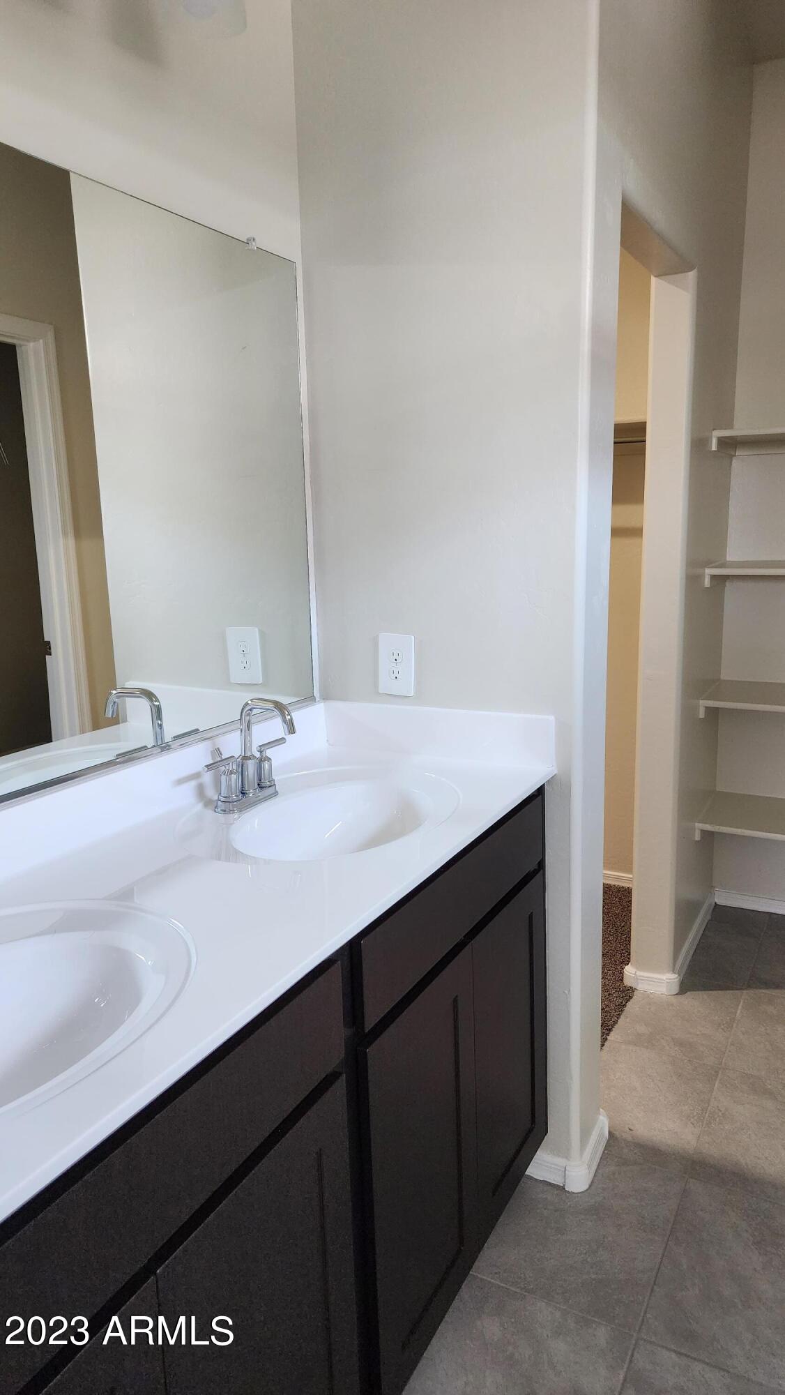 18045 North Conquistador Drive Maricopa, AZ 85138 - Photo 8 of 12 a bathroom with a sink and a mirror