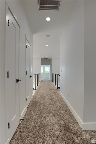 828 South Deer Road Tooele, UT 84074 - Photo 36 of 51 Contemporary hallway featuring carpet flooring, crisp white walls, recessed lighting, and modern black railings