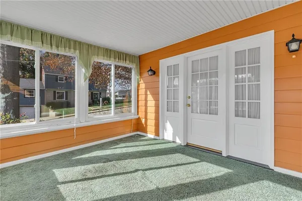 a view of porch with a black white door
