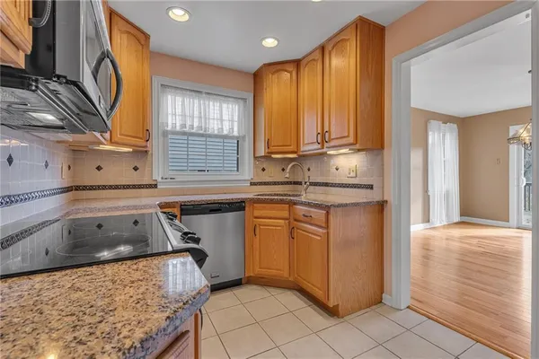 a kitchen with a sink stove and cabinets