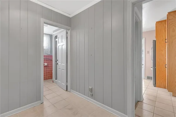 a view of a hallway with wooden shelves