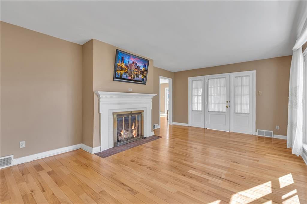 198 Oak Street Beaver, PA 15009 - Photo 9 of 39 a view of empty room with wooden floor and fireplace