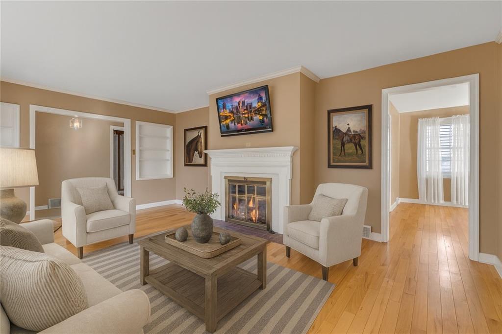 198 Oak Street Beaver, PA 15009 - Photo 10 of 39 a living room with furniture a fireplace and a wooden floor