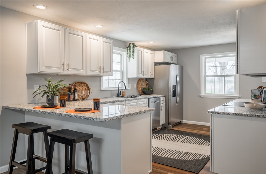 8240 Looney Road Piqua, OH 45356 - Photo 11 of 49 This bright and airy kitchen boasts ample counter space and modern appliances, perfect for everyday living.