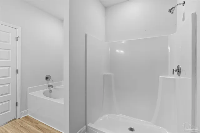 a bathroom with a bathtub and shower