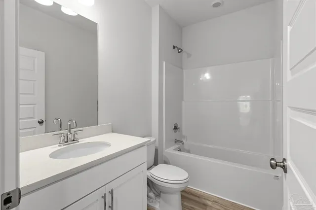 a bathroom with a sink toilet tub and shower