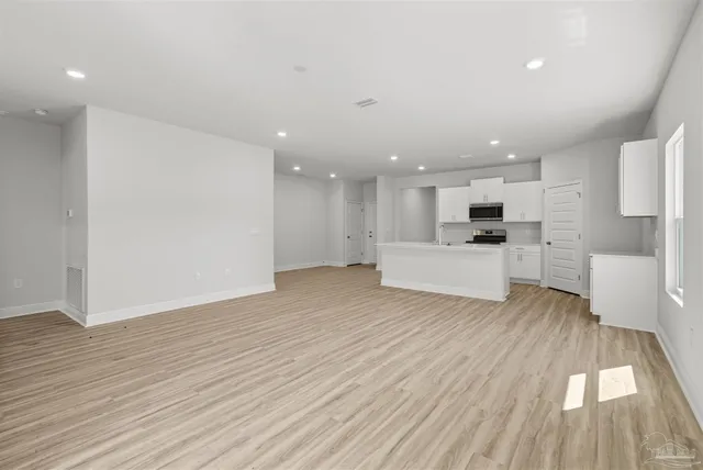 a view of kitchen with cabinets and wooden floor