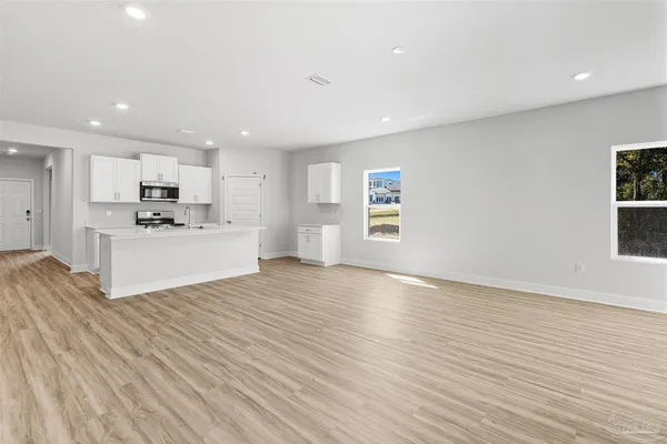 a view of a kitchen with microwave and cabinets