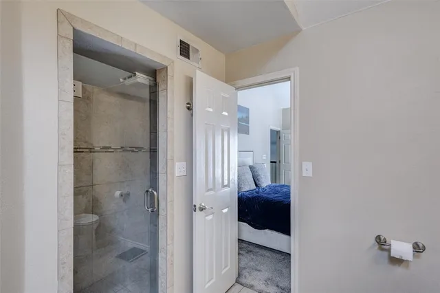 a bathroom with a shower and a toilet