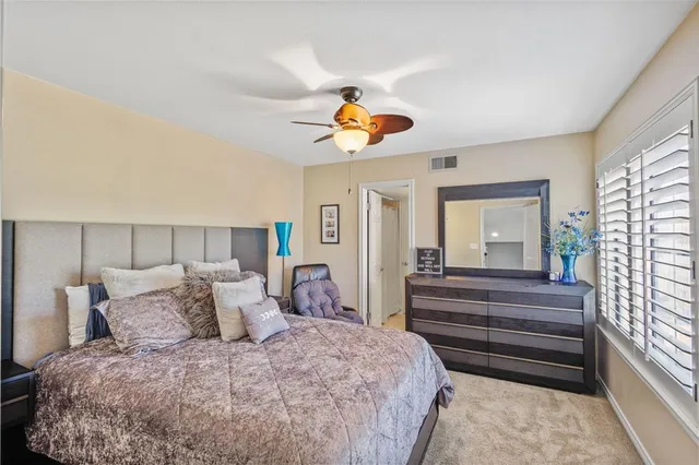 a bedroom with bed and wooden floor