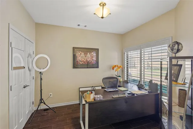 a view of a workspace with furniture and a window