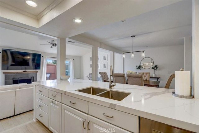 a kitchen with sink white cabinets and stove