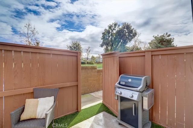 a backyard of a house with a fire pit and outdoor seating
