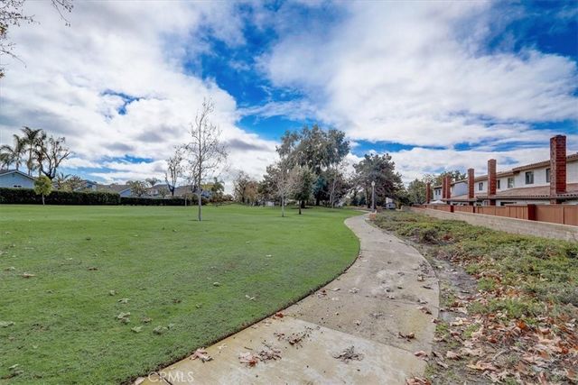 a view of a field with grass and trees