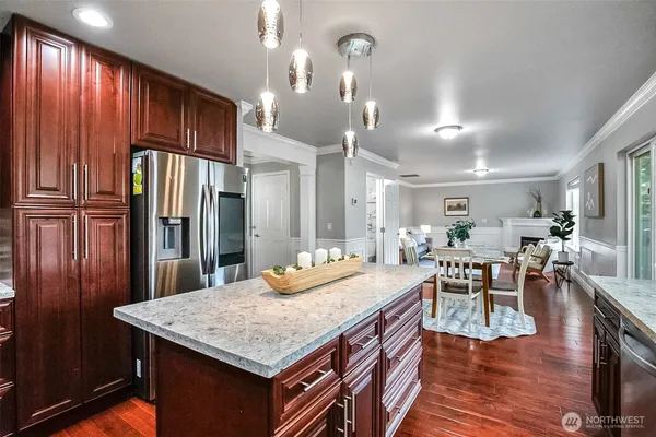 a view of a dining room with furniture wooden floor and a floor to ceiling window