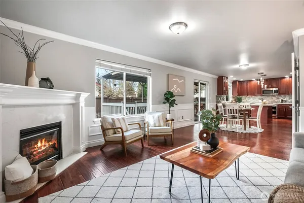 a living room with furniture a window and potted plants