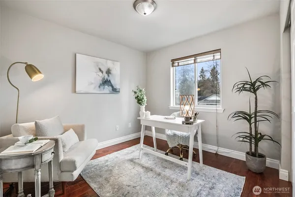 a living room with furniture potted plant and a window