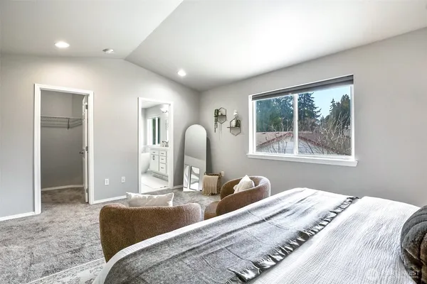 a bedroom with bed and a window