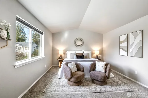 a bathroom with a large tub sink and mirror