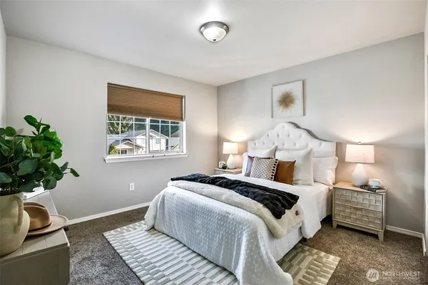 a bedroom with a bed and a potted plant
