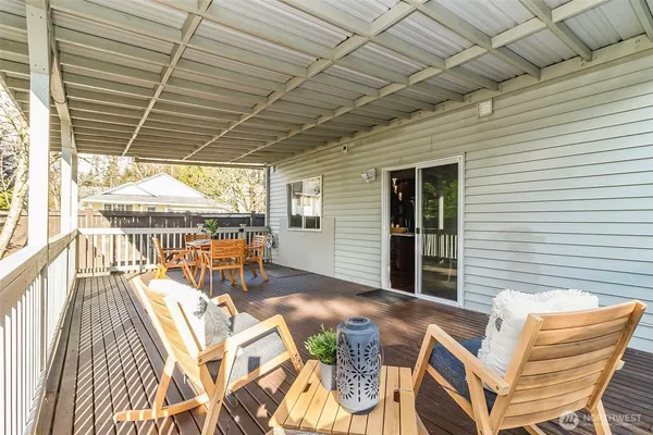 a view of a backyard with a small cabin and wooden fence