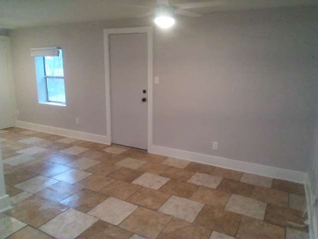 2113 River Road, Unit C San Marcos, TX 78666 - Photo 2 of 9 Spare room with a ceiling fan and stone finish flooring