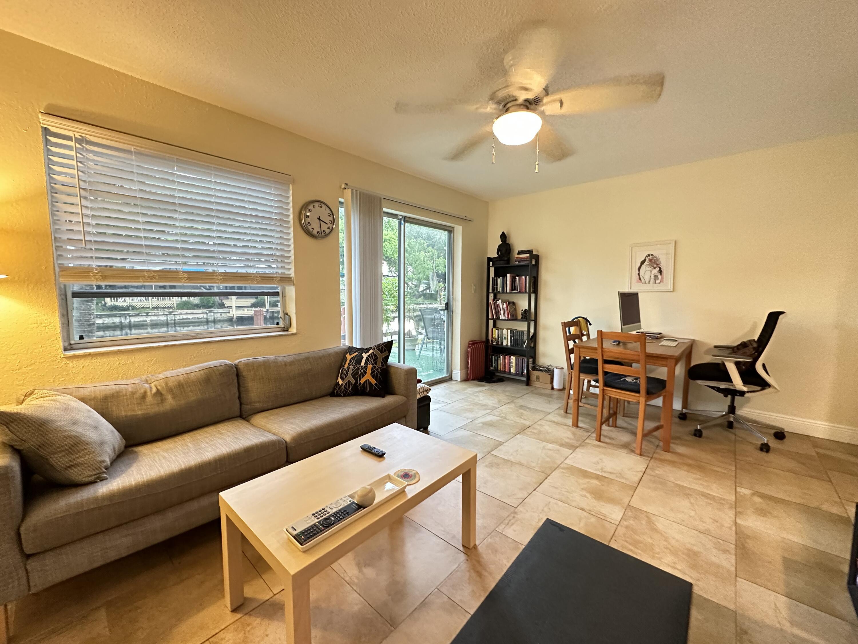5811 Northeast 14th Road, Unit 1 Fort Lauderdale, FL 33334 - Photo 4 of 16 a living room with furniture and a large window