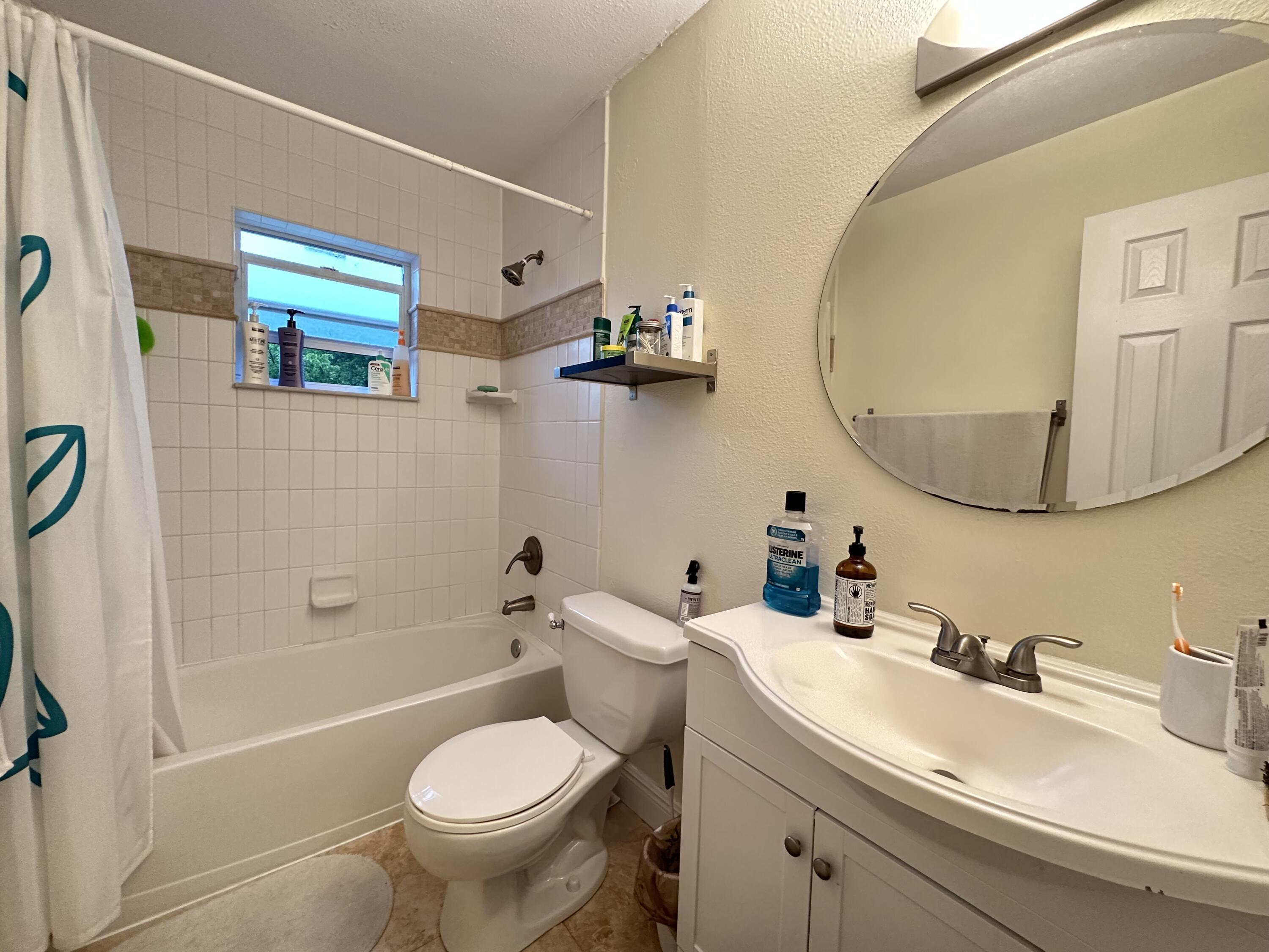 5811 Northeast 14th Road, Unit 1 Fort Lauderdale, FL 33334 - Photo 6 of 16 a bathroom with a sink mirror toilet and vanity