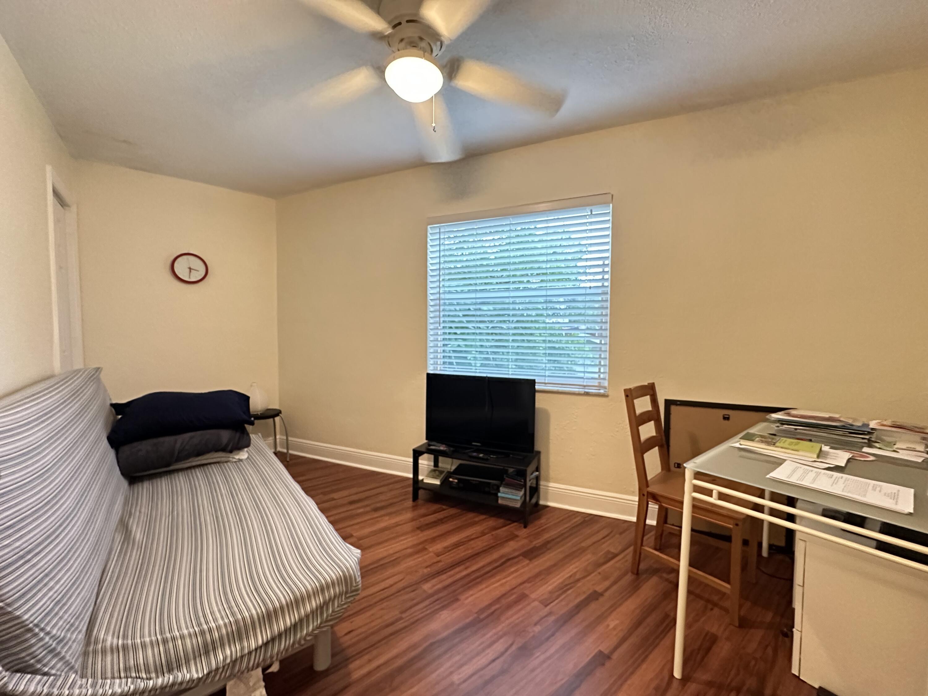 5811 Northeast 14th Road, Unit 1 Fort Lauderdale, FL 33334 - Photo 8 of 16 a bedroom with a bed and wooden floor