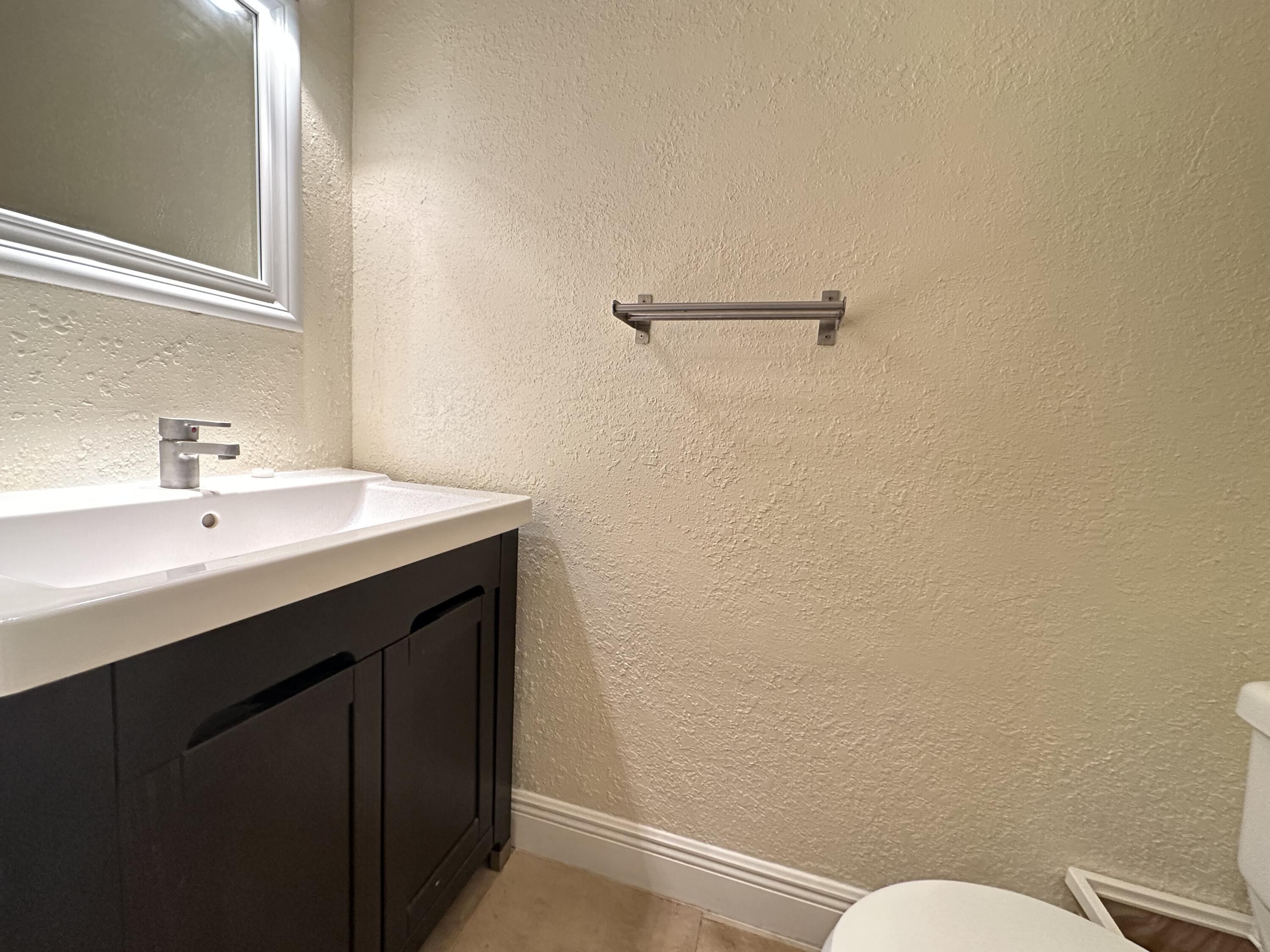 5811 Northeast 14th Road, Unit 1 Fort Lauderdale, FL 33334 - Photo 9 of 16 a bathroom with a sink mirror and toilet